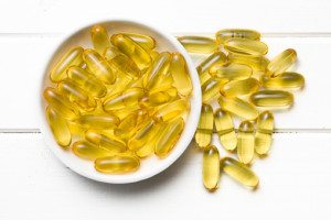 Cod liver oil. Gel capsules in bowl