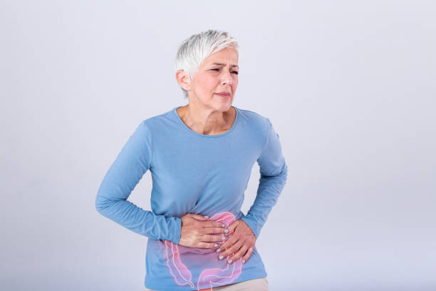 photo of large intestine is on the senior woman body against gray background, People With Stomach ache problem concept, Female anatomy