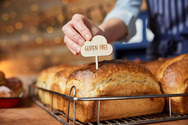 Bakery Putting Gluten Free Label Into Freshly Baked Baked Sourdough Loaves Of Bread