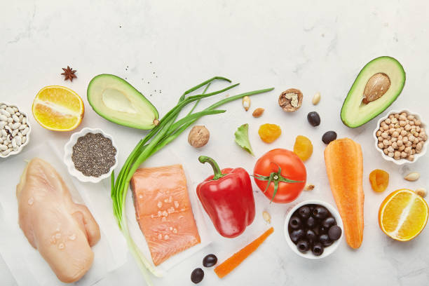 Low fodmap ingredients diet - seafish, chicken meat, vegetables and fruits, nuts, greens, beans. Fodmap diet concept. Flat lay.