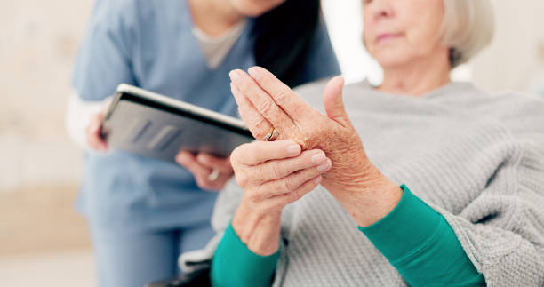 Image of a dietitian holding a stack of papers in hand which are test results. Hands, talking and a woman with a doctor for a consultation, arthritis problem or joint pain. Healthcare, home care and a senior patient speaking to a nurse about a finger accident with notes.