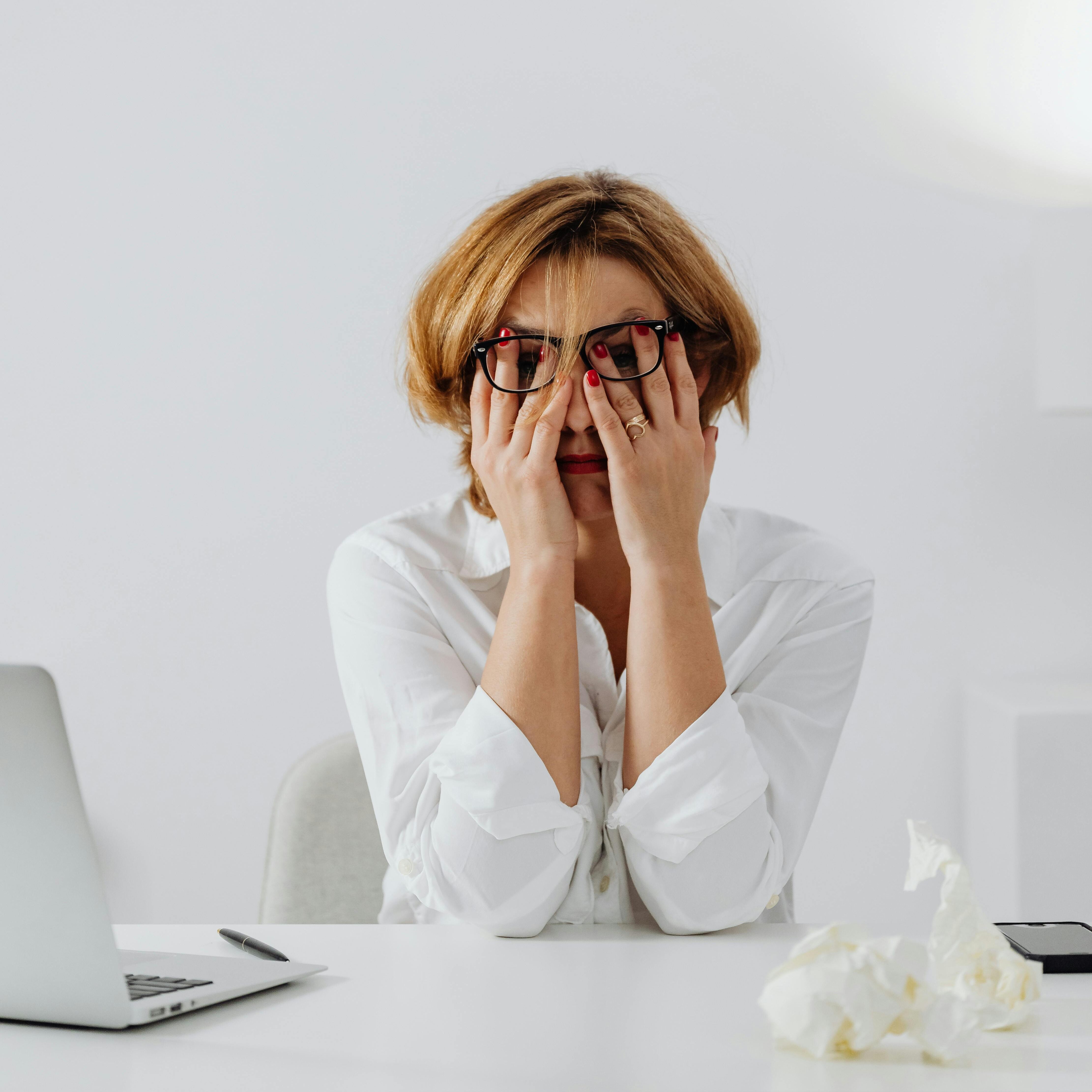 Image of a dietitian holding a stack of papers in hand which are test results. old woman stressed out.