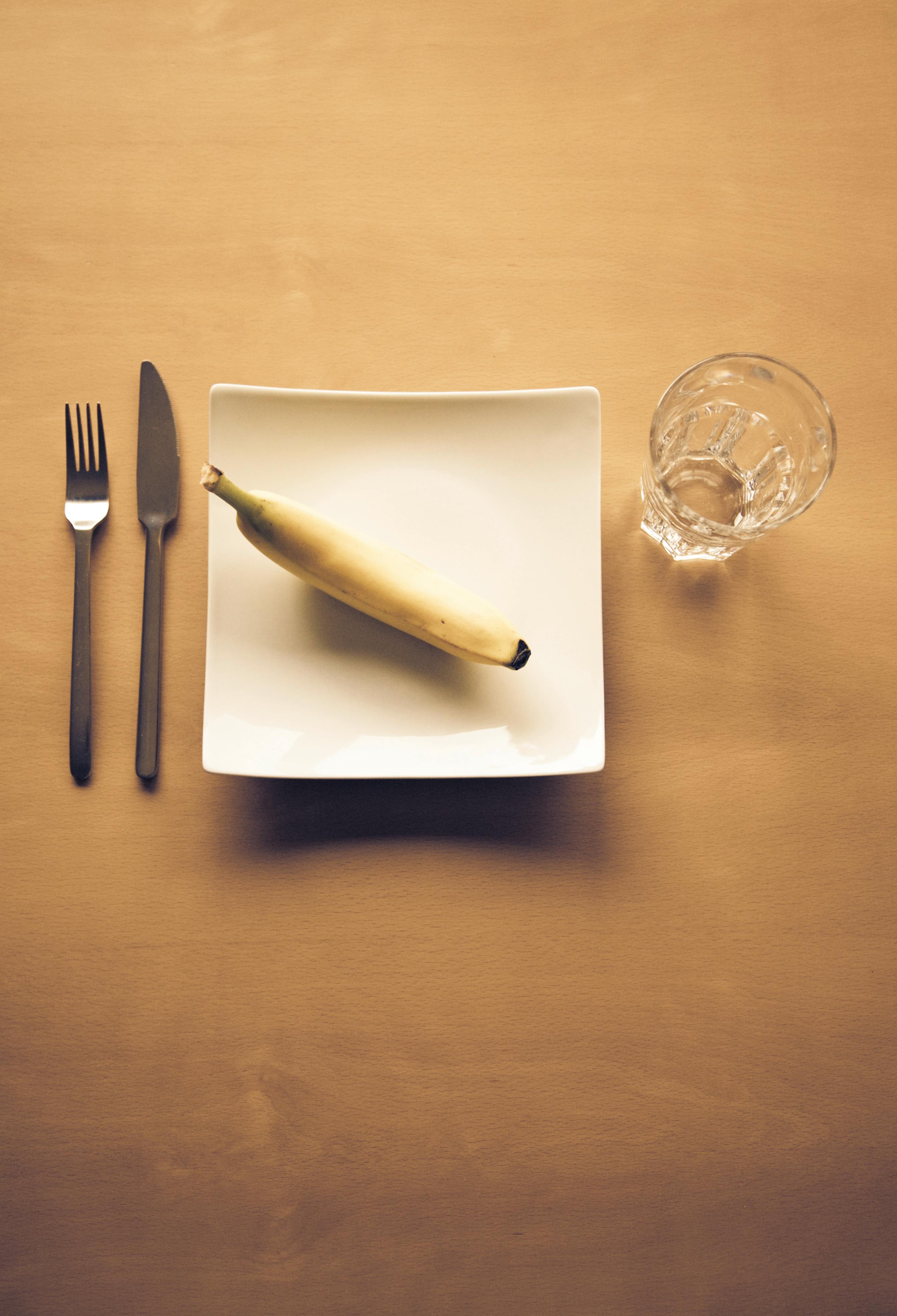 Image of an antimicrobial sitting on a table. banana on a plate.