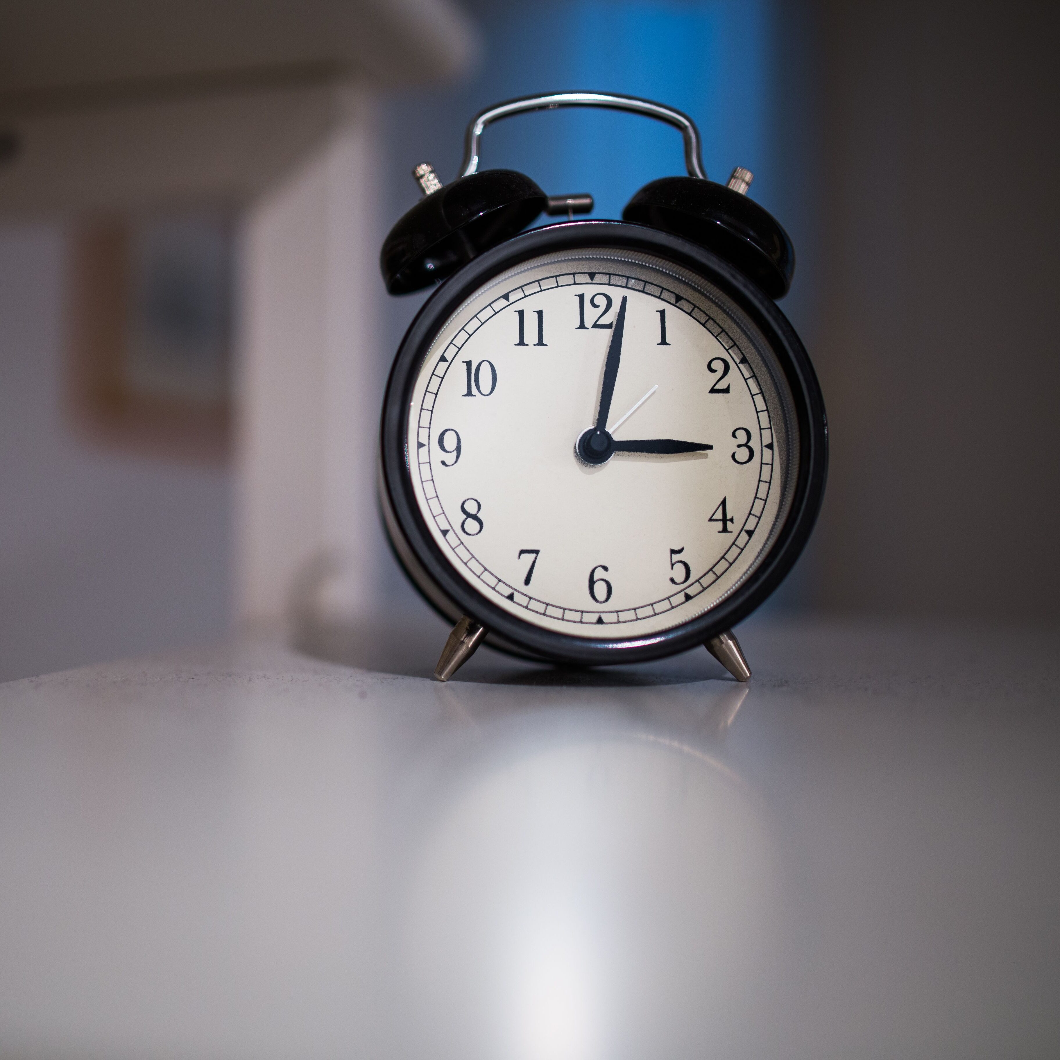black clock on a white table