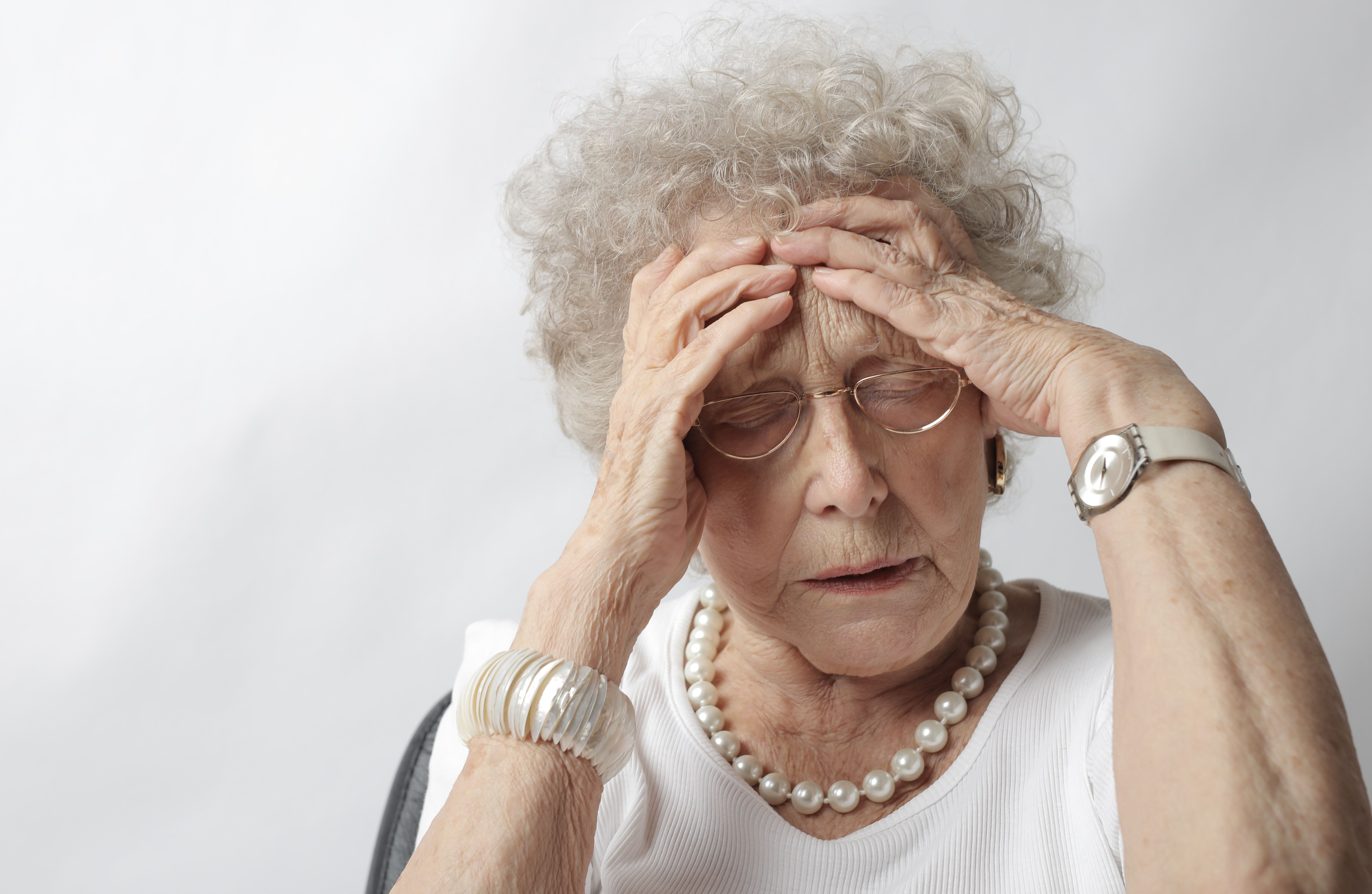 old woman stressed out and it's triggered her gut issues