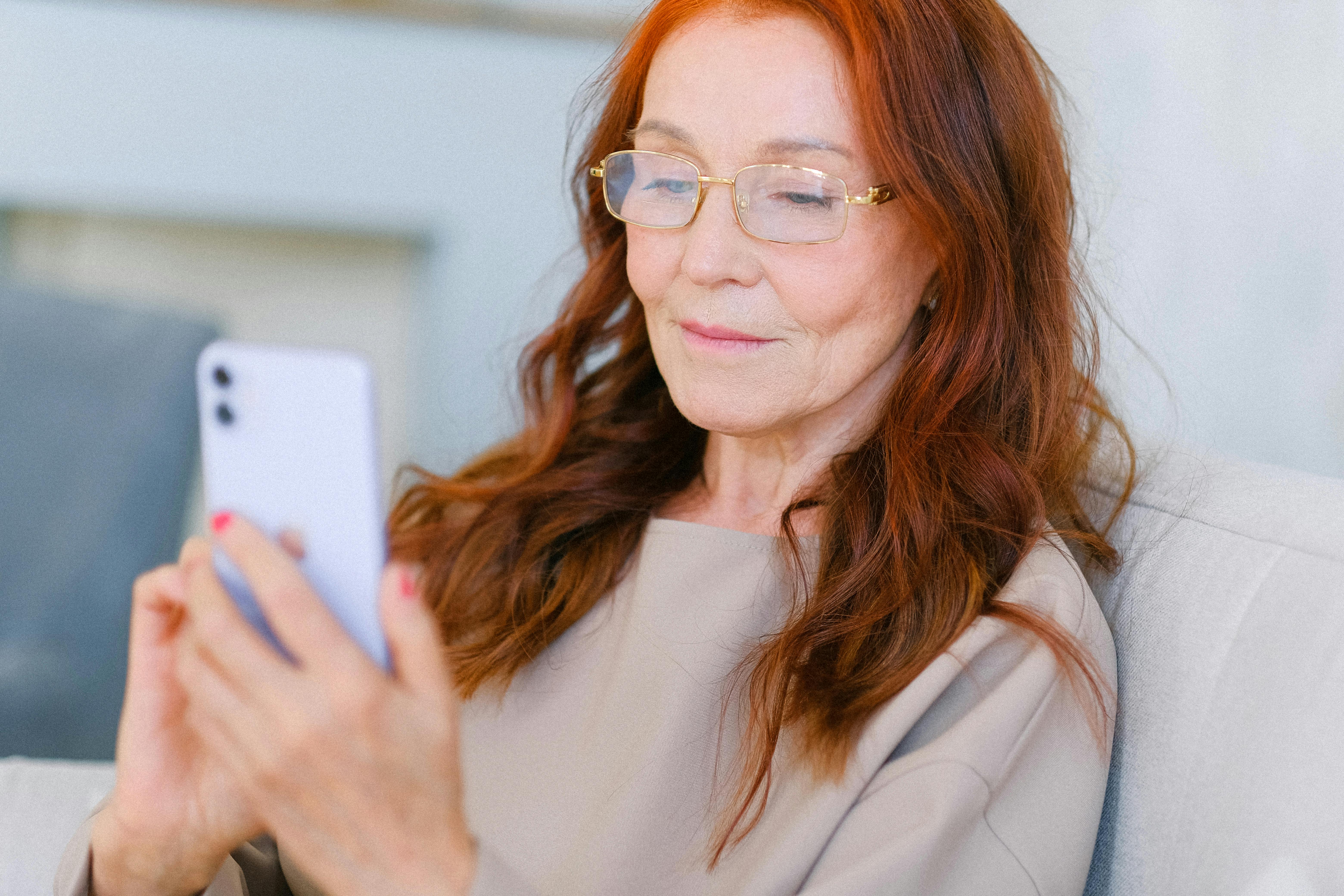 Image of a dietitian holding a stack of papers in hand which are test results. old woman using a phone to help calm her IBS issues.