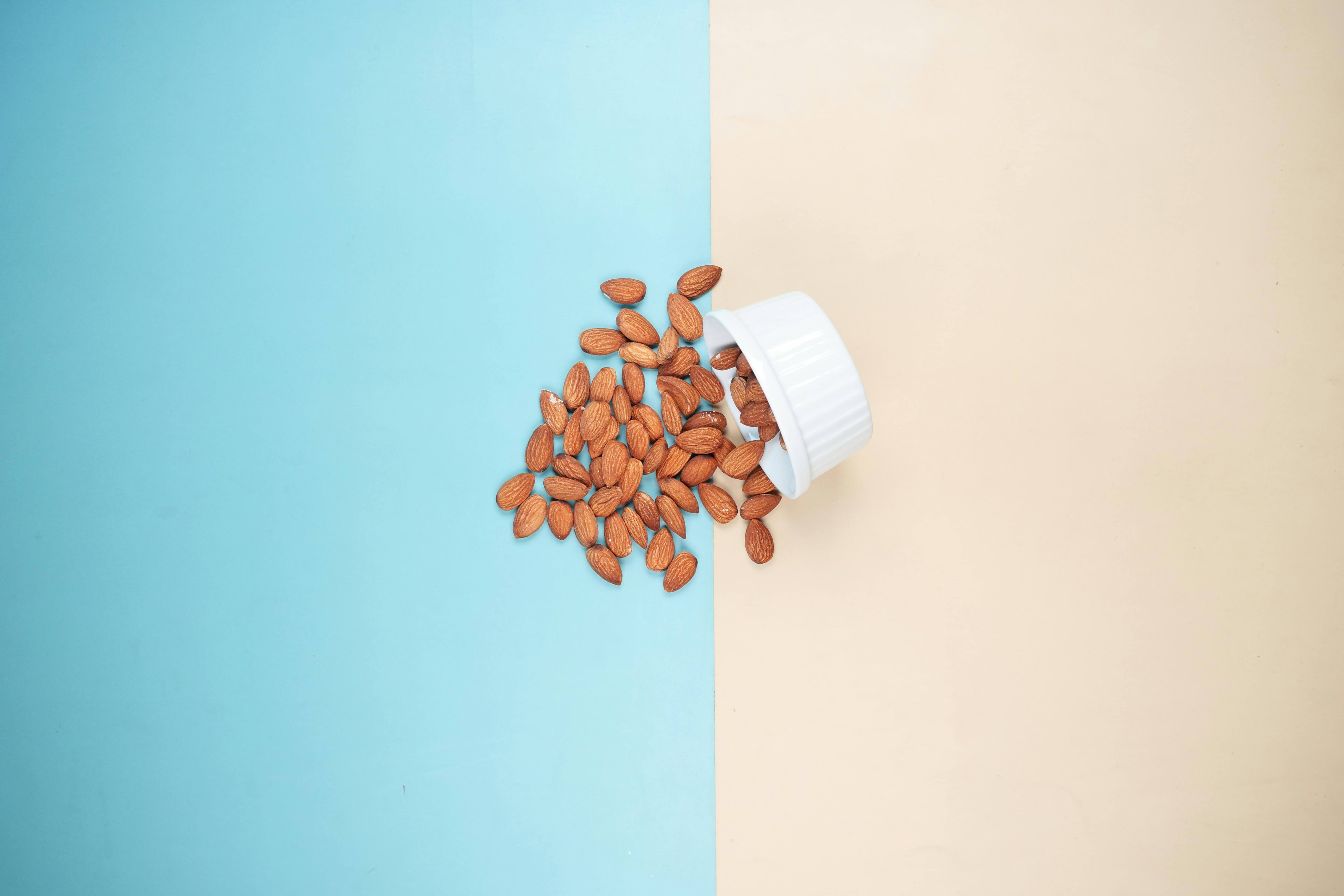 Image of an antimicrobial sitting on a table. Cup of almonds.